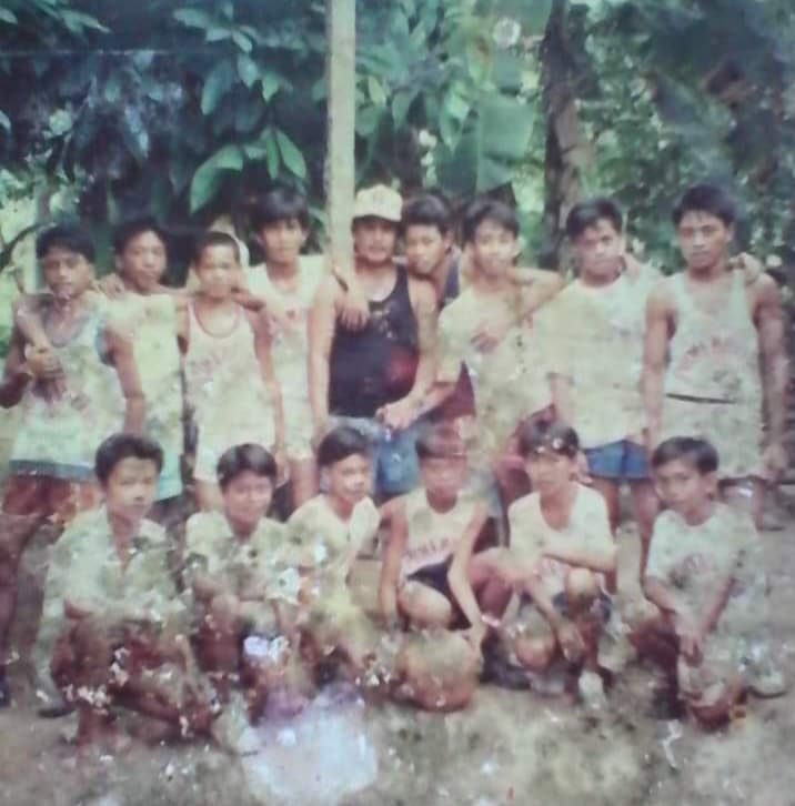 A badly damaged old team photo of the Primemovers basketball team outdoors